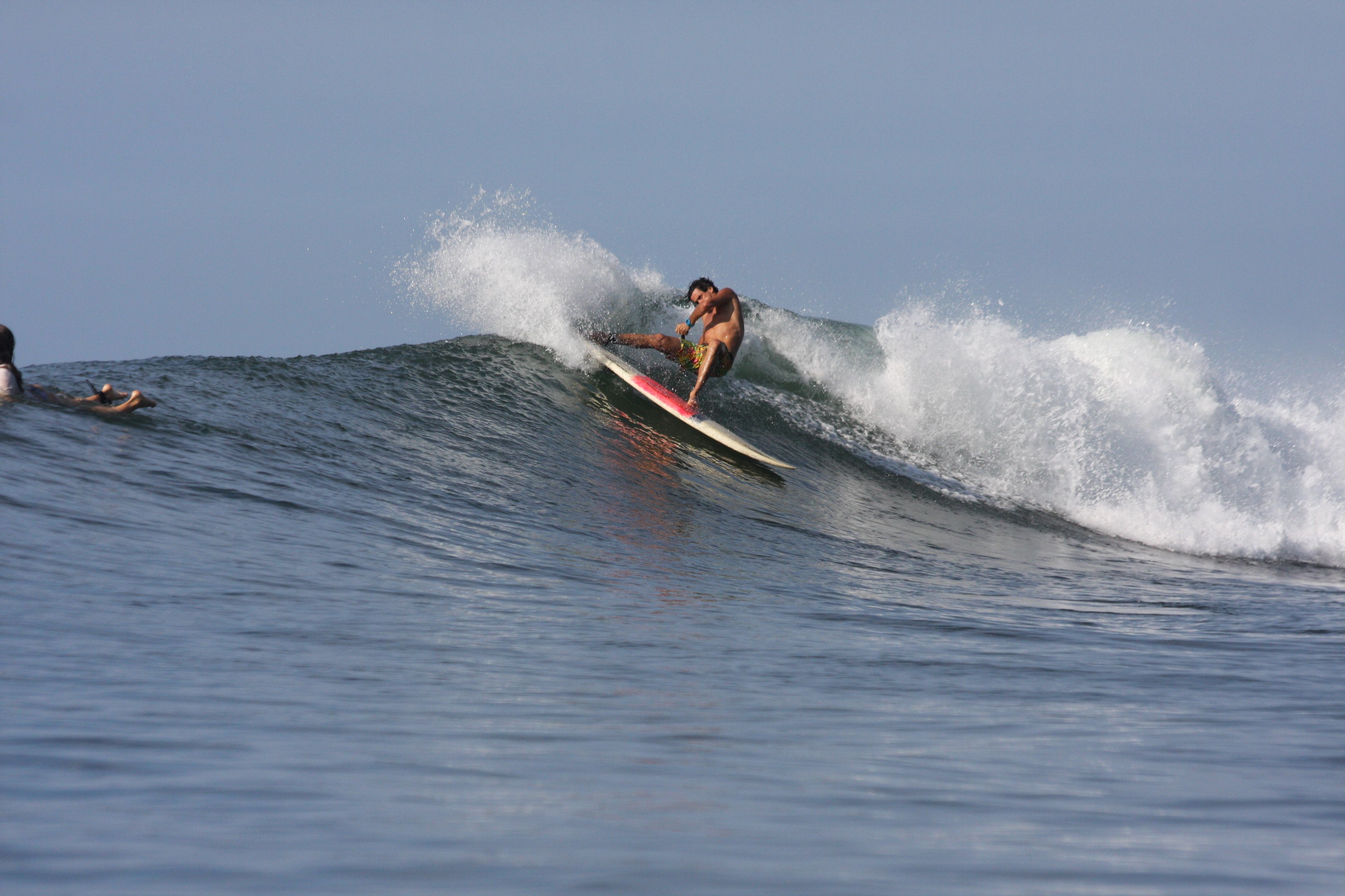 Surfer riding a wave at El Zonte
